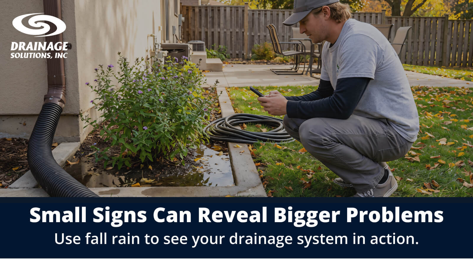 Person inspecting standing water near a home&rsquo;s downspout after fall rain.