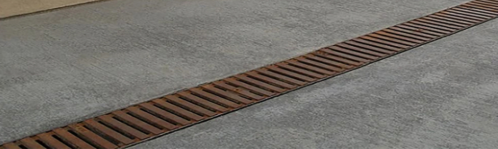 The Iron Age Raw Cast Iron Regular Joe Grate 5" is a decorative, durable trench drain grate with a traditional slotted design, designed to fit 5-inch-wide drainage channels from ABT, ACO and MEA. 