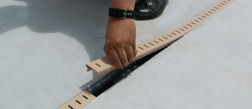 Channel drain installed in yard to guide water away from problem areas